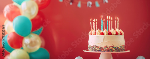 Birthday party with birthday cake, candles, balloons on red background with empty copy space,