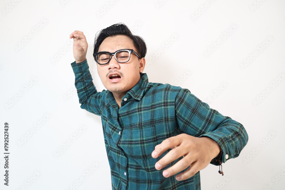 Fototapeta premium Mature Asian man wearing green flannel suffering from lower back pain