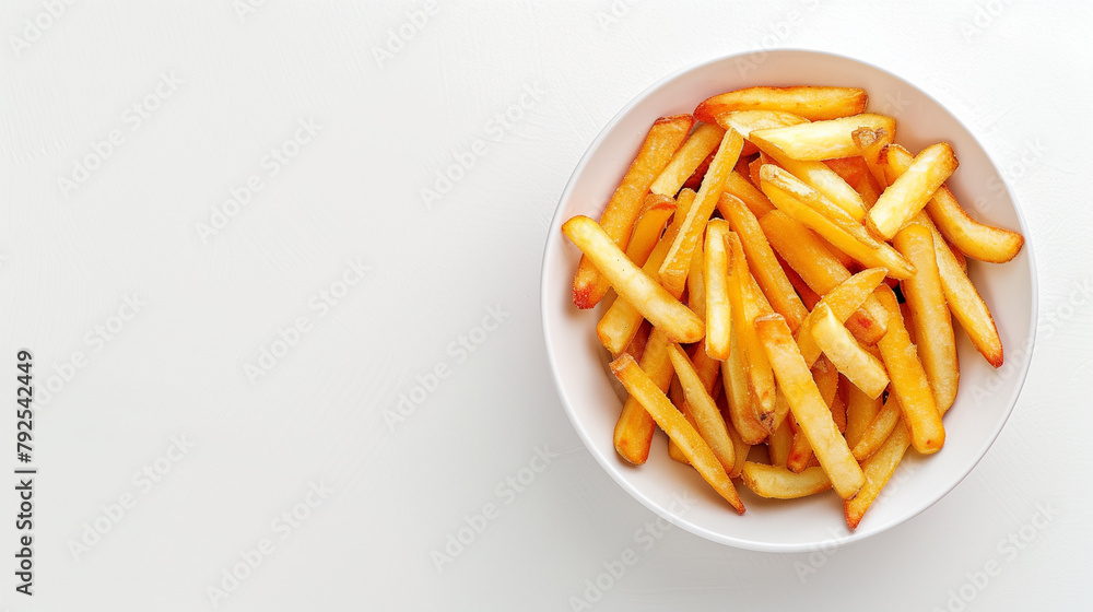French fries in a bowl on a white table, top view, space on the left French fries in a bowl on a white table, top view, space on the left