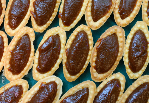Traditional oriental sweets jam tartlets put on plate. Meal served during celebrating great islamic holiday Nowruz