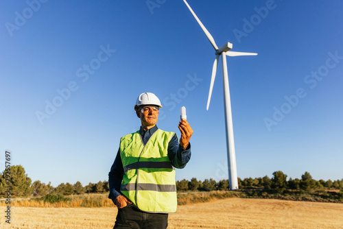 Engineer expert in renewable and clean energy holding energy saving light bulb.