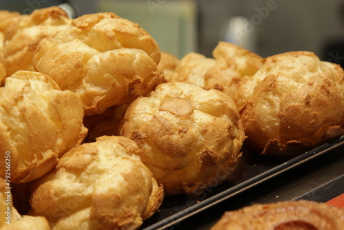 Selective focus of choux pastry. Homemade choux pastry or cream puffs or eclair with vanilla custard cream. French dessert. Look like noised with white background. photo