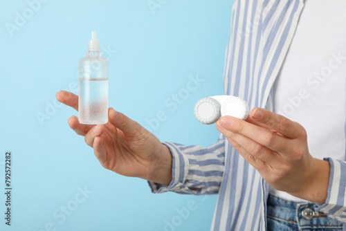 Contact lens liquid with lens container in hand photo