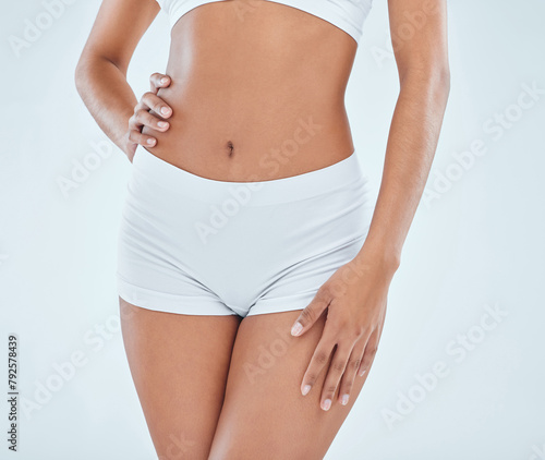 Woman, flat stomach and underwear in studio, fitness and skincare on white background. Female person, abdomen and confident for body care or weight loss, wellness and lingerie for slim treatment