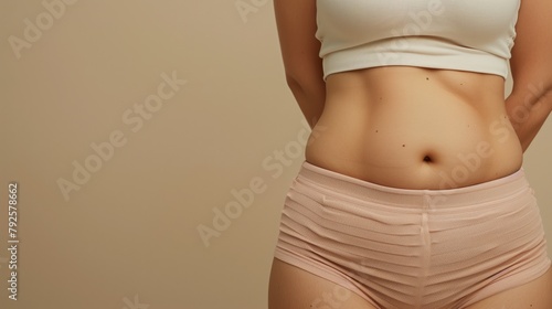 Close-up of a woman's midsection wearing a white crop top and pink underwear