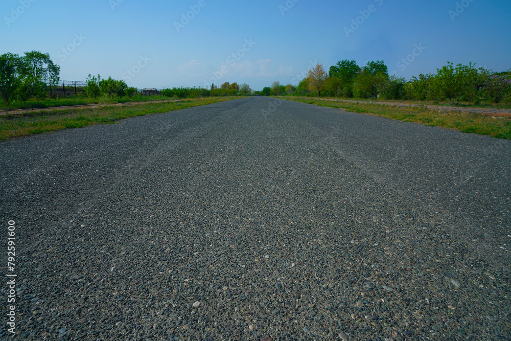 empty Asphalt road without cars and green tree with city skyline. speed motion on highway in summer with green forest at countryside. empty Asphalt road without cars and green tree with city skyline. speed motion on highway in summer with green forest at countryside.