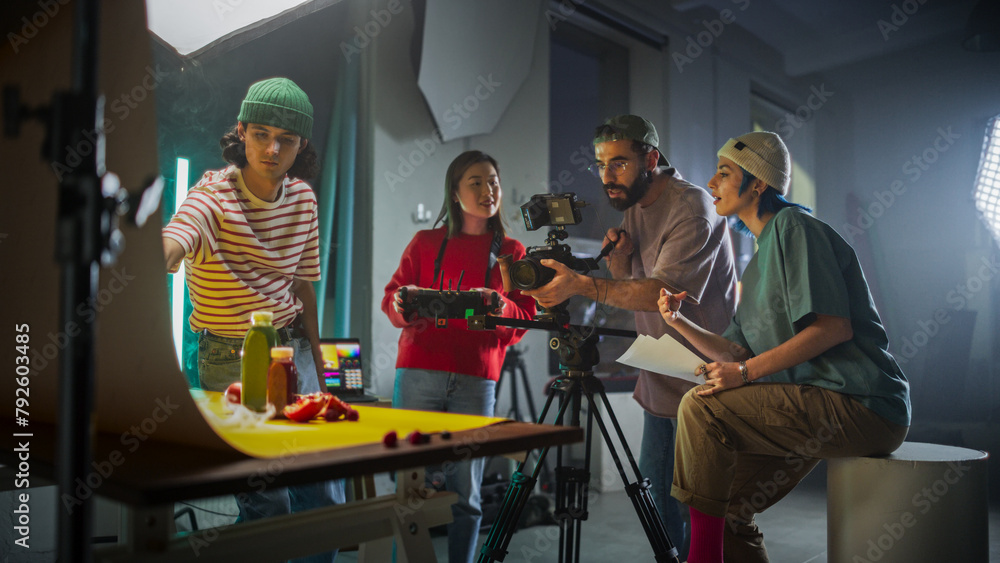 Diverse Young Filmmakers Collaborate On A Vibrant Set, Focusing On A Camera Setup While Discussing Scene Details, Reflecting Creativity And Teamwork In Modern Videography And Advertising Production.