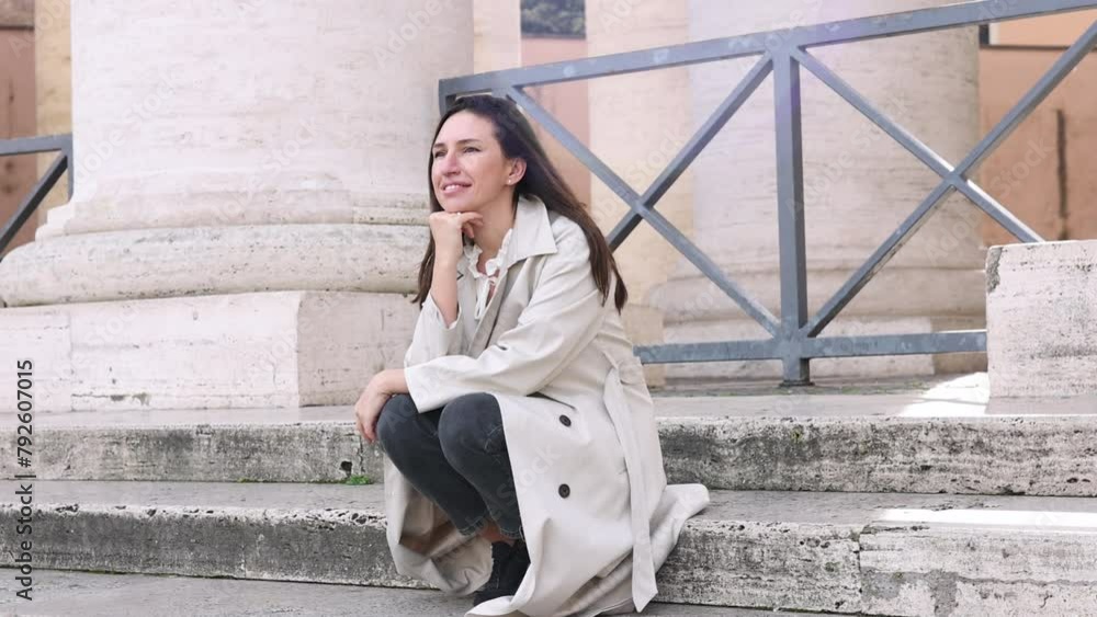 giant white columns and road between.woman female posing, in long coat. girl sitting in sunlight, take sit down on stairs or running.architectural antique temple.sunny spring day giant white columns and road between.woman female posing, in long coat. girl sitting in sunlight, take sit down on stairs or running.architectural antique temple.sunny spring day