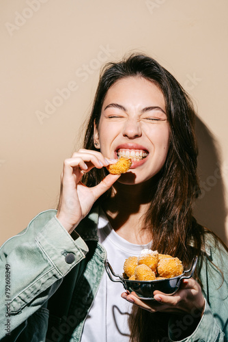 Wallpaper Mural Cheerful young woman enjoying fried cheese balls Torontodigital.ca