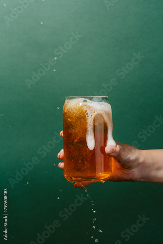 Refreshing light beer overflowing from a glass photo