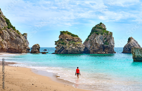 Woman walking at the stunning beach of the Praia do Ribeiro do Cac´valo, maybe the must beautiful bay in Portugal near Sesimbra
 photo
