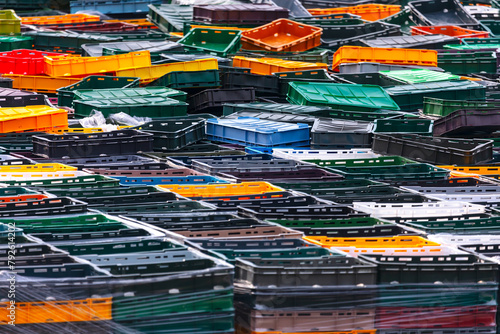 A lot of colorful plastic containers for waste sorting and recycling. Industrial background