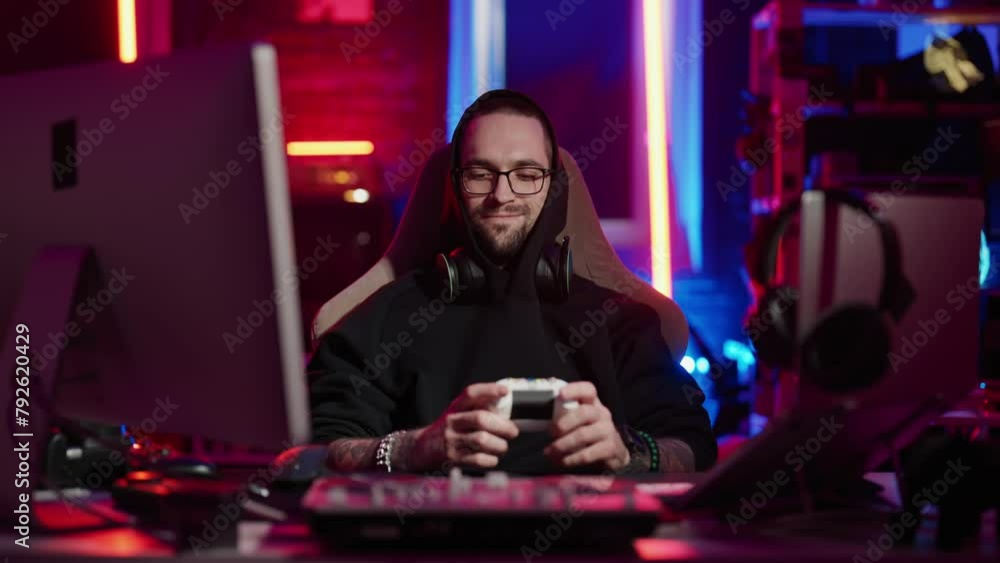 Man gamer playing virtual video games. Professional gamer guy sitting at computer monitor console joystick, playing virtual online video game winner expression. Internet gambling addiction concept. Man gamer playing virtual video games. Professional gamer guy sitting at computer monitor console joystick, playing virtual online video game winner expression. Internet gambling addiction concept.