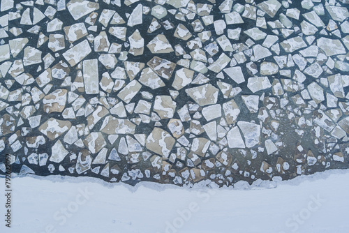 Photo background texture of ice floes floating in off the coast of the Baltic Sea, photo from a drone looking down.