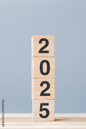 wooden cube block with 2025 text on table background. Resolution, plan, review, goal, start and New Year holiday concepts photo