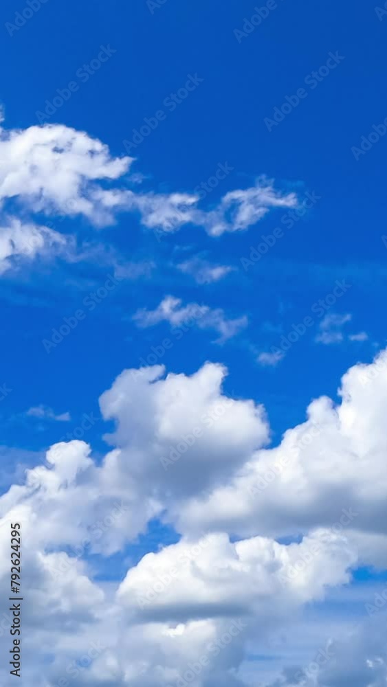 Heavenly beautiful cumulus clouds transforming in the blue skies. Light spindrift clouds at backdrop. Timelapse. Vertical video Heavenly beautiful cumulus clouds transforming in the blue skies. Light spindrift clouds at backdrop. Timelapse. Vertical video