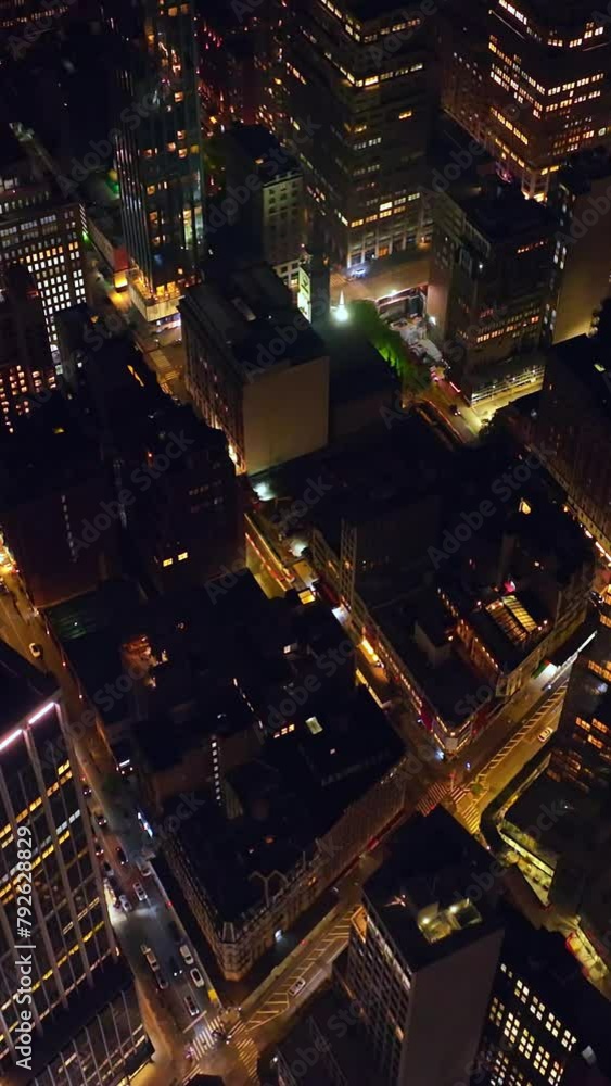 Flying high above the lively traffic streets at night time. Splendid Manhattan architecture from aerial perspective. Vertical video Flying high above the lively traffic streets at night time. Splendid Manhattan architecture from aerial perspective. Vertical video