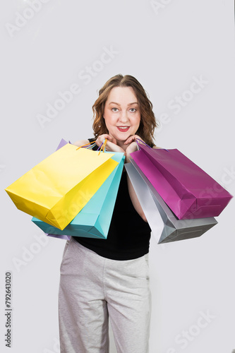 Cheerful woman holding colored shopping bags in ruah. High quality photo photo