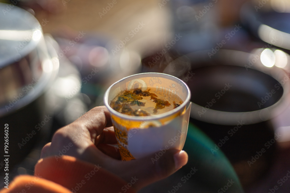 Selective focus Yellow dried chrysanthemum flowers in a hot water glass in the morning. Refreshing, gentle, and fragrant chrysanthemum hot tea drink in the morning. Selective focus Yellow dried chrysanthemum flowers in a hot water glass in the morning. Refreshing, gentle, and fragrant chrysanthemum hot tea drink in the morning.