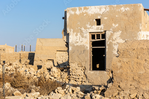 Ruined abandoned Al Jazirah Al Hamra haunted town in Ras Al Khaimah, United Arab Emirates, with demolished buildings.