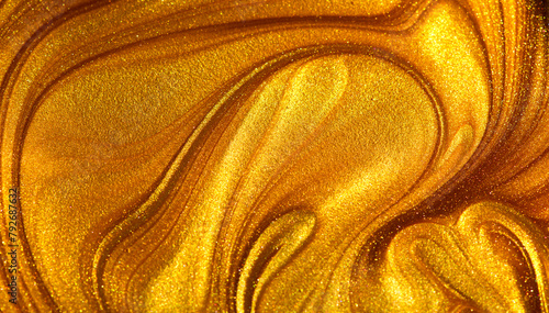 Beautiful abstract golden liquid paint background, beauty gold backdrop texture. Metallic gold paint, art design. Yellow shimmering surface close-up. Golden bright glitter texture, macro shot  © Subbotina Anna