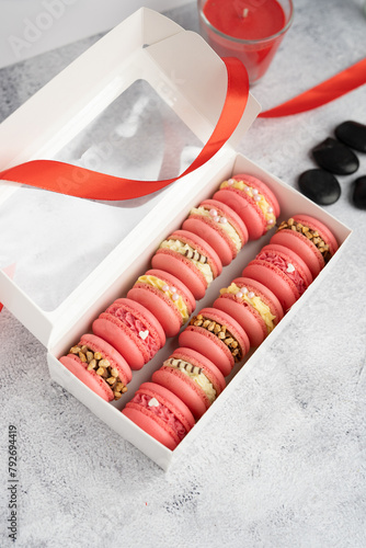 Macaroons with different fillings in a box close-up.