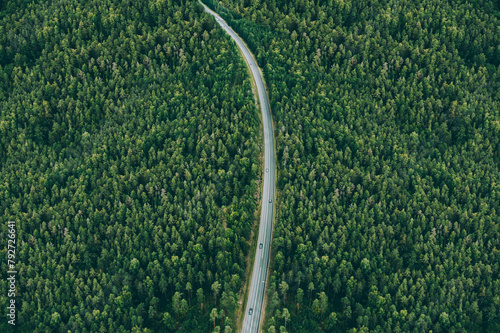 Aerial view of country road with cars and green summer woods © nblxer