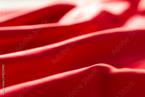 The bright red silk satin surface is beautiful and luxurious, wavy. For background and graphic work Blurry or blurry