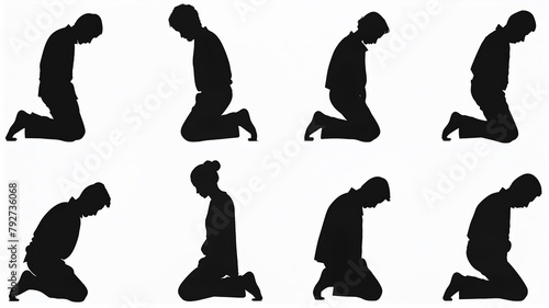 Silhouette of a group of christian people kneeling in prayer photo