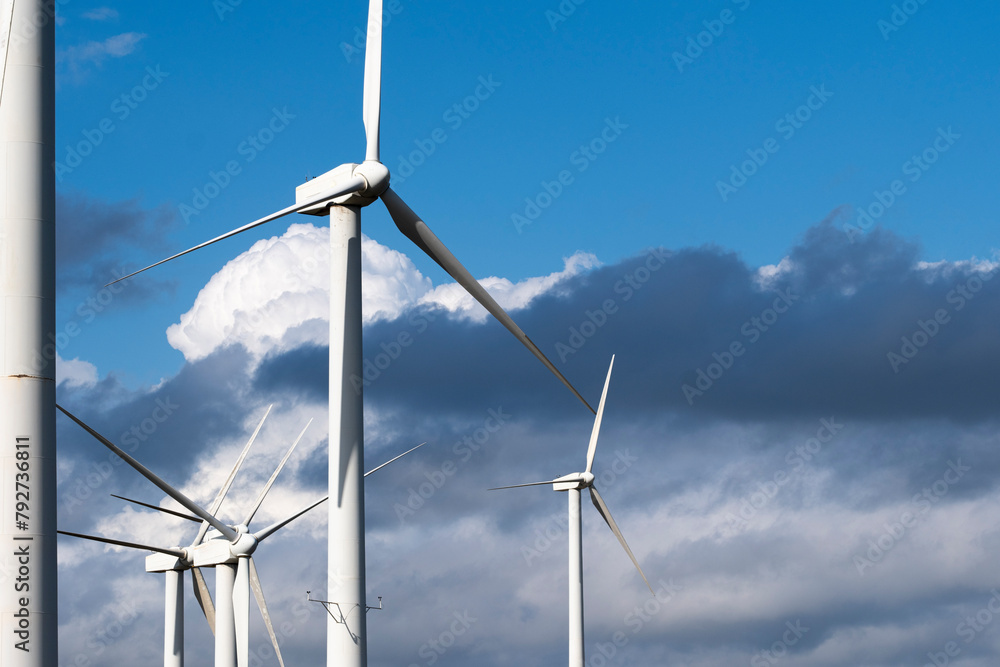 © yaqui_villegas - Expansive view of a wind turbines farm under dancing clouds, reflecting the eco-friendly energy mesmerizing Catalonia, Spain, and Tarragona © yaqui_villegas - Expansive view of a wind turbines farm under dancing clouds, reflecting the eco-friendly energy mesmerizing Catalonia, Spain, and Tarragona
