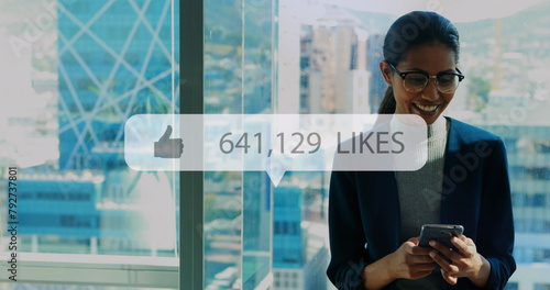 Image of like icon with growing number over biracial businesswoman using smartphone