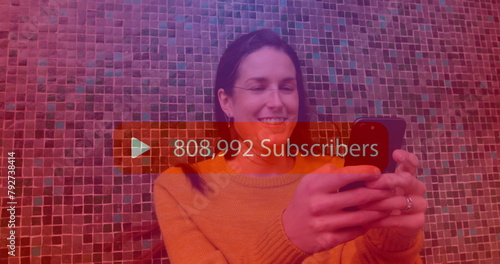 Image of subscribers text with growing number over caucasian woman using smartphone