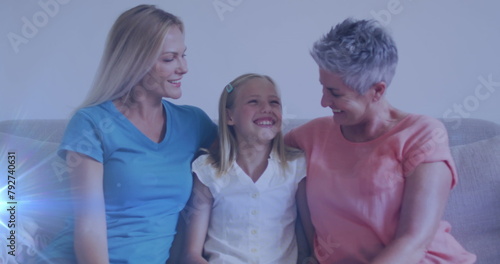 Image of glowing spots over happy caucasian grandmother, mother and daughter