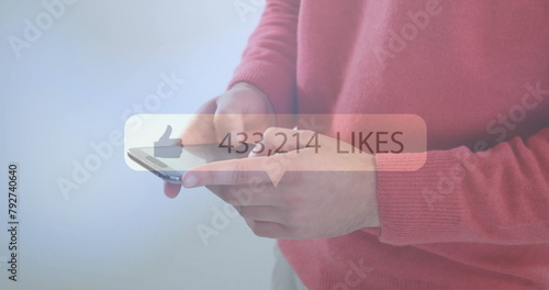 Image of likes text with growing number over caucasian man using smartphone