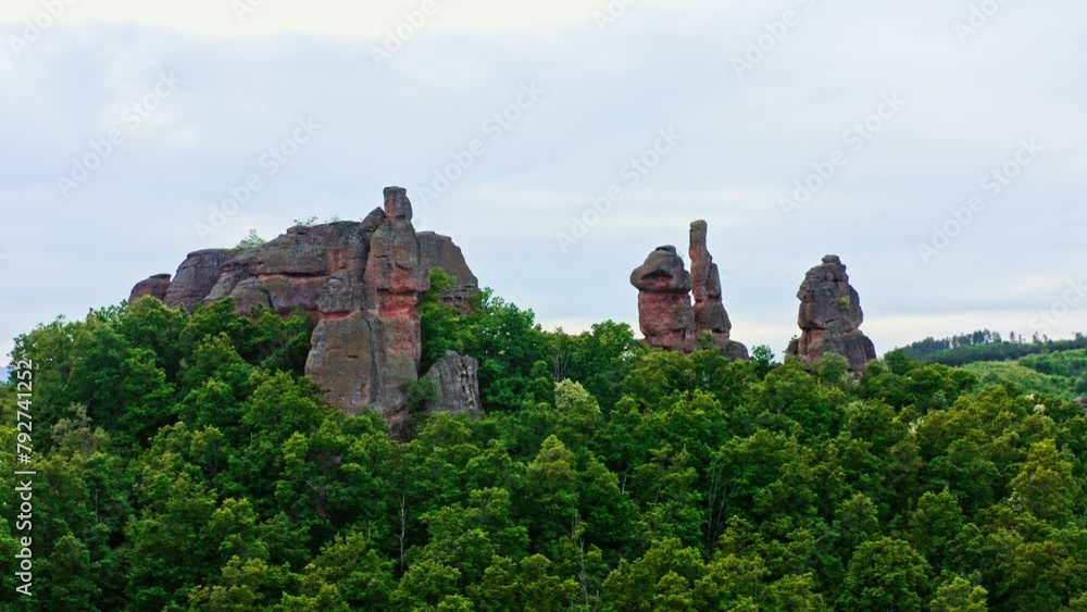 Belogradchik sandstone rock formations rise above Bulgarian forest landscape, drone shot Belogradchik sandstone rock formations rise above Bulgarian forest landscape, drone shot