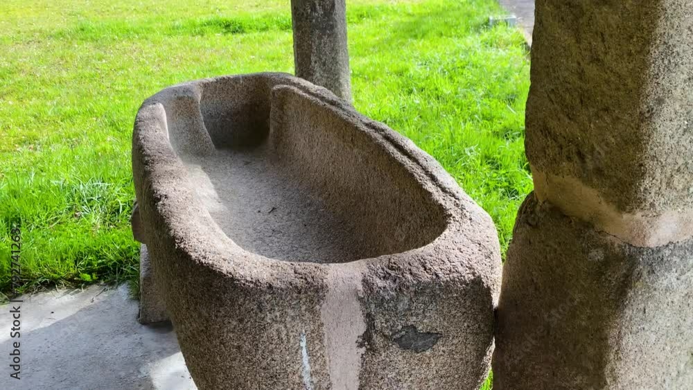 Stone bowl basin carved and well worn at corner of old church property Stone bowl basin carved and well worn at corner of old church property