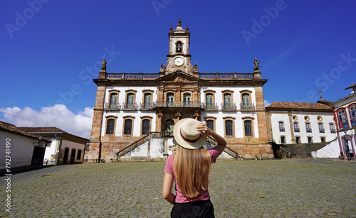 Tourism in Ouro Preto, Brazil. Young tourist woman visiting Tiradentes Square famous landmark of Ouro Preto city, Unesco world heritage site in Minas Gerais state, Brazil. photo