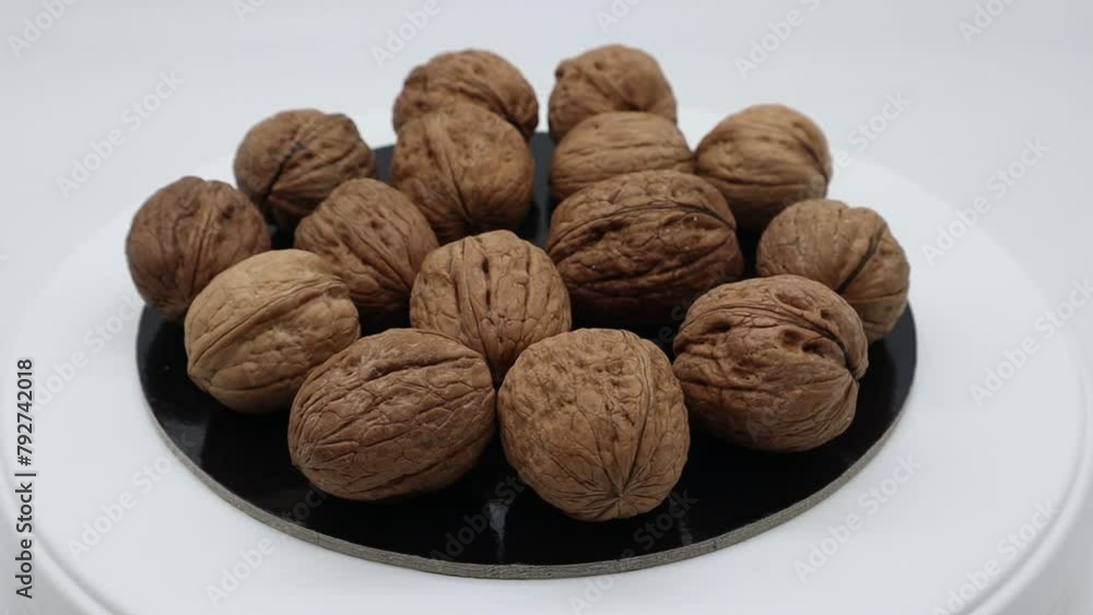 Walnuts on turntable isolated on white background Walnuts on turntable isolated on white background