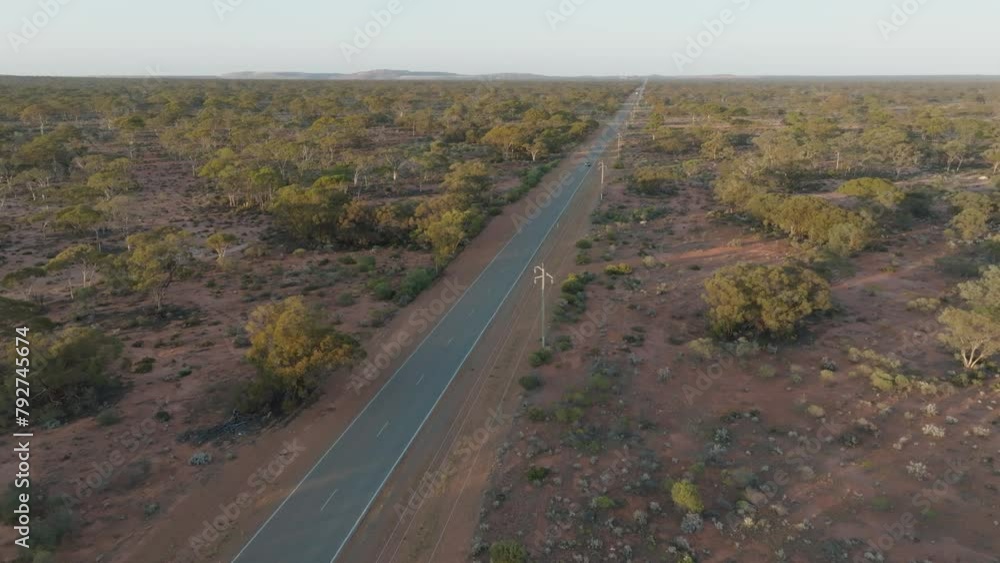 Drone clip showing cars driving along isolated rural road through Australian outback Drone clip showing cars driving along isolated rural road through Australian outback