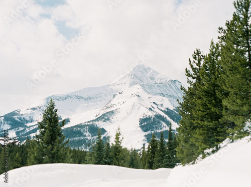 Snow covered Lone Peak looks over a wintery Montana landscape