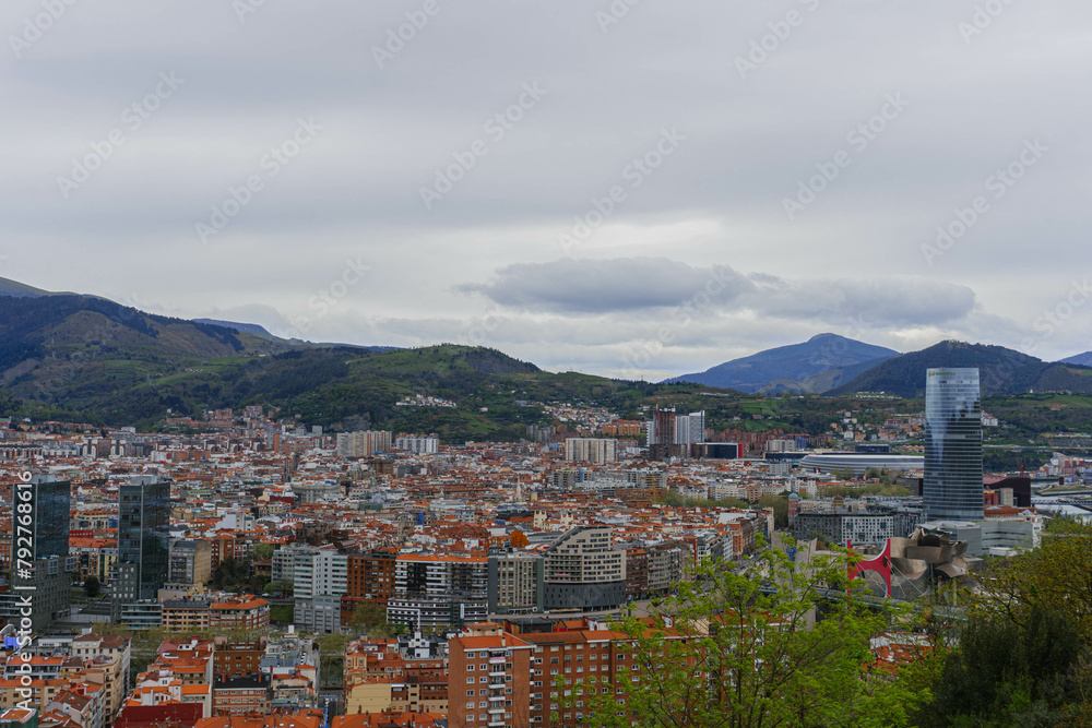 panorama of the city of bilbao with cloudy sky and mountains 
