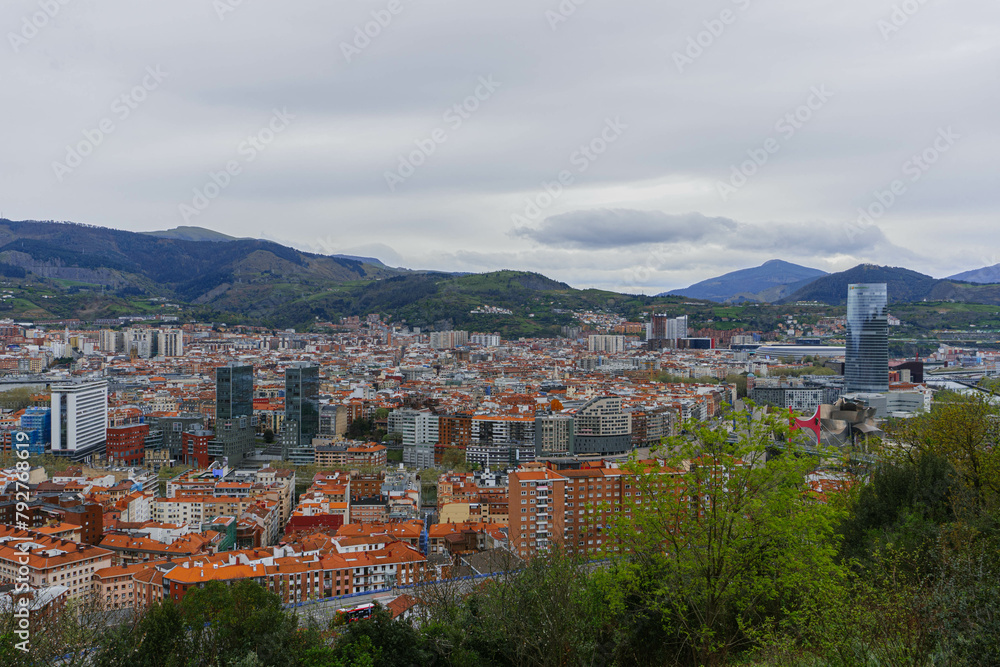 panorama of the city of bilbao with cloudy sky and mountains 
