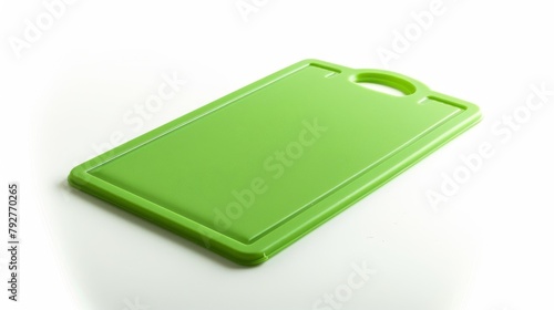 Green Plastic Cutting Board on White Surface, A bright green plastic cutting board with handle, perfect for kitchen food preparation, shown on a clean white surface. photo