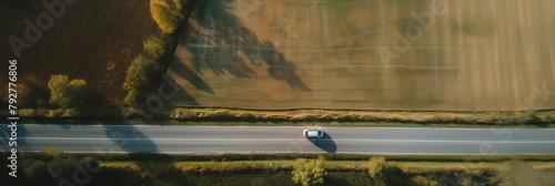 Car Driving on a Long Straight Road at Sunset