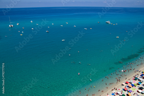 Sea beach with turquoise water and sand where people relax © Alekss