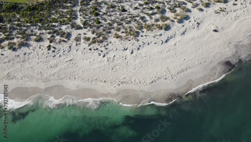 Drone aerial panning up from the beach to the coastal town of Jurien Bay in Australia photo