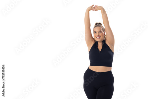 A Caucasian plus size model on white background stretches her arms up, copy space