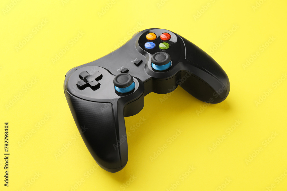 One wireless game controller on yellow background One wireless game controller on yellow background