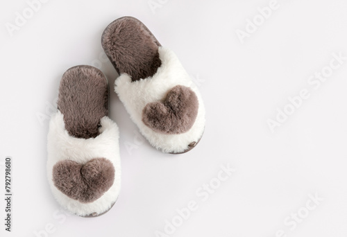 Cozy warm fury slippers on the white background. Empty place for text. Top view