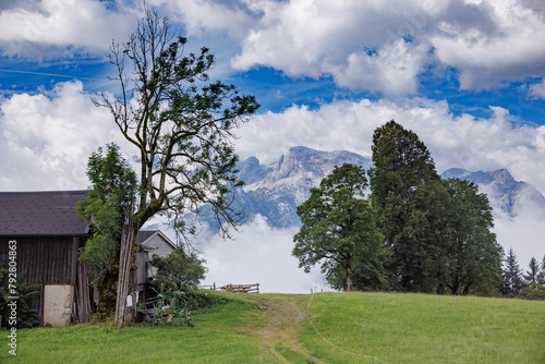 Austrian Mountain Peaks with Barn and Path in Summer photo